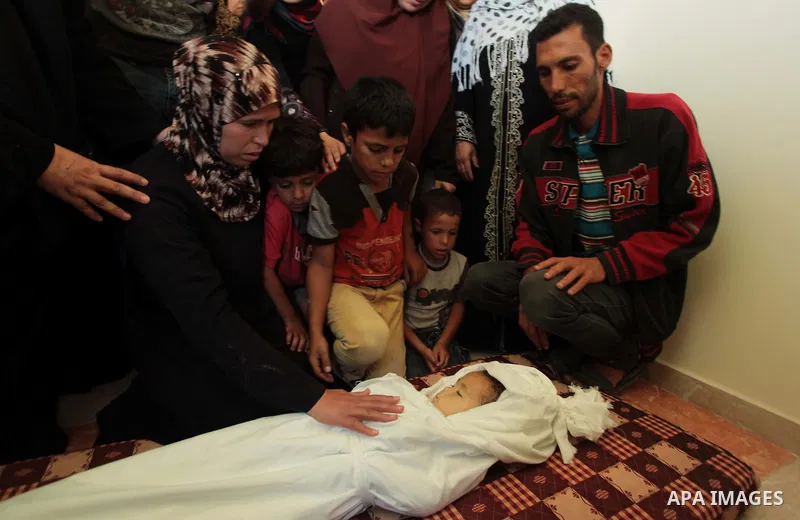 Relatives of three-year-old Palestinian girl Jud al-Danaf gather to bid farewell to her body during her funeral in Gaza City June 25, 2014. The Gaza girl was killed and three of her family were wounded in an explosion wh...