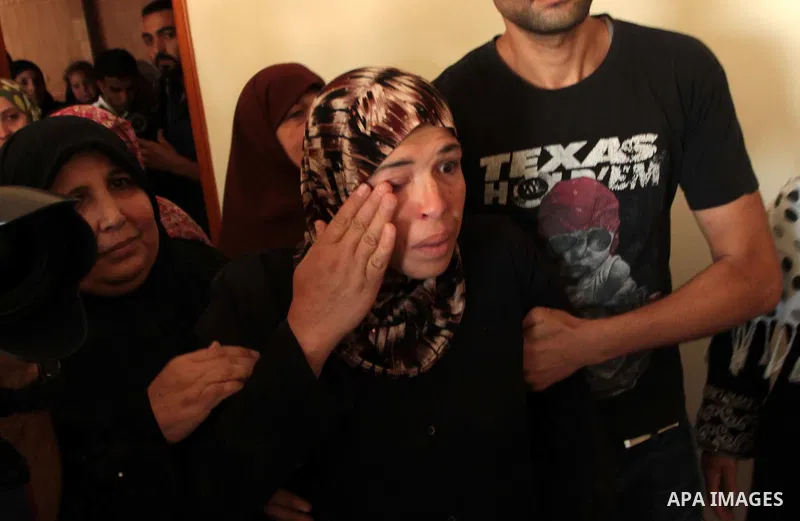 The mother of three-year-old Palestinian girl Jud al-Danaf mourns during her funeral, in Gaza City June 25, 2014. The Gaza girl was killed and three of her family were wounded in an explosion which residents blamed on Is...