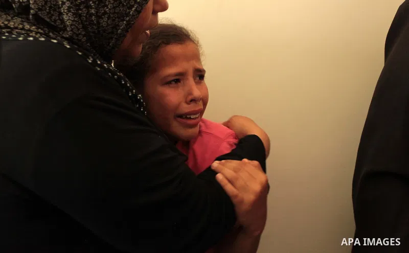The sister of three-year-old Palestinian girl Jud al-Danaf mourns during her funeral, in Gaza City June 25, 2014. The Gaza girl was killed and three of her family were wounded in an explosion which residents blamed on Is...