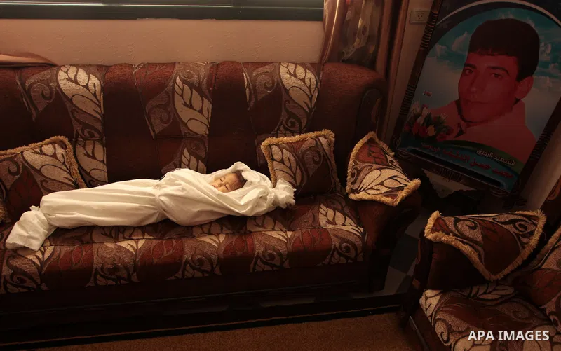 The body of three-year-old Palestinian girl Jud al-Danaf before her funeral, in Gaza City June 25, 2014. The Gaza girl was killed and three of her family were wounded in an explosion which residents blamed on Israel. The...