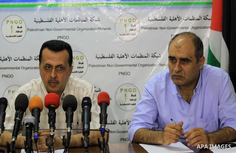 A Palestinian member of the Network of NGOs speaks during a press conference in Gaza city on June 25, 2014. Photo by Mohammed Asad