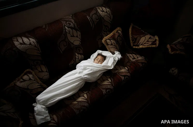 The body of three-year-old Palestinian girl Jud al-Danaf her daughter during her funeral, in Gaza City June 25, 2014. The Gaza girl was killed and three of her family were wounded in an explosion which residents blamed o...