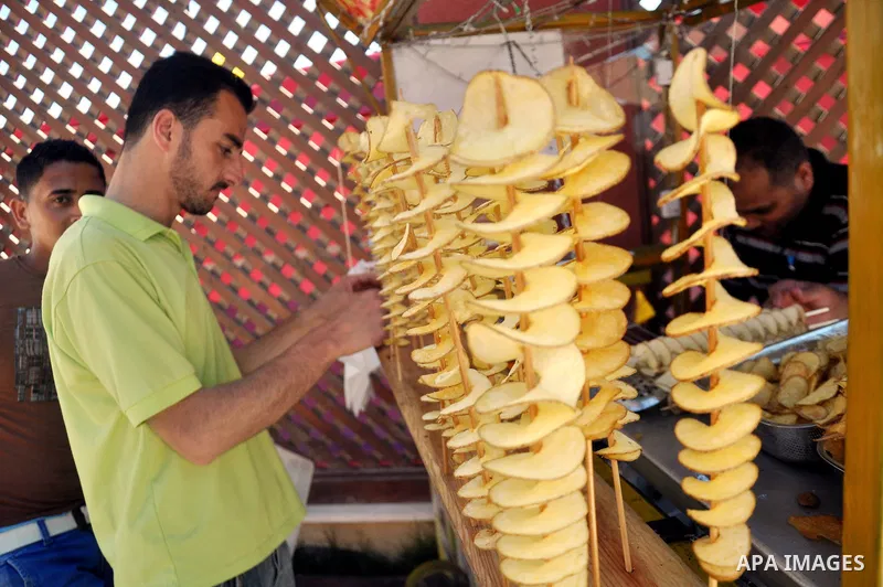 Palestinians take part in the Palestinian food exhibition, organized by the general union of Palestinian industries, in Gaza City on June 25, 2014. Photo by Mohammed Talatene