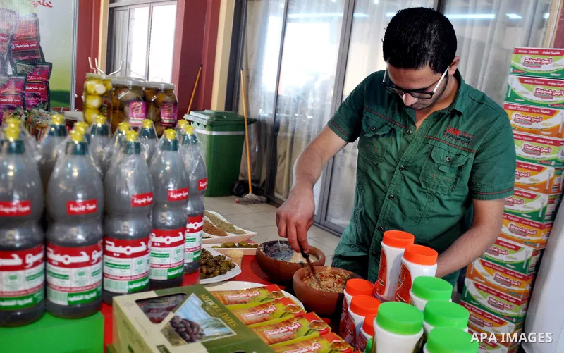 Palestinians take part in the Palestinian food exhibition, organized by the general union of Palestinian industries, in Gaza City on June 25, 2014. Photo by Mohammed Talatene