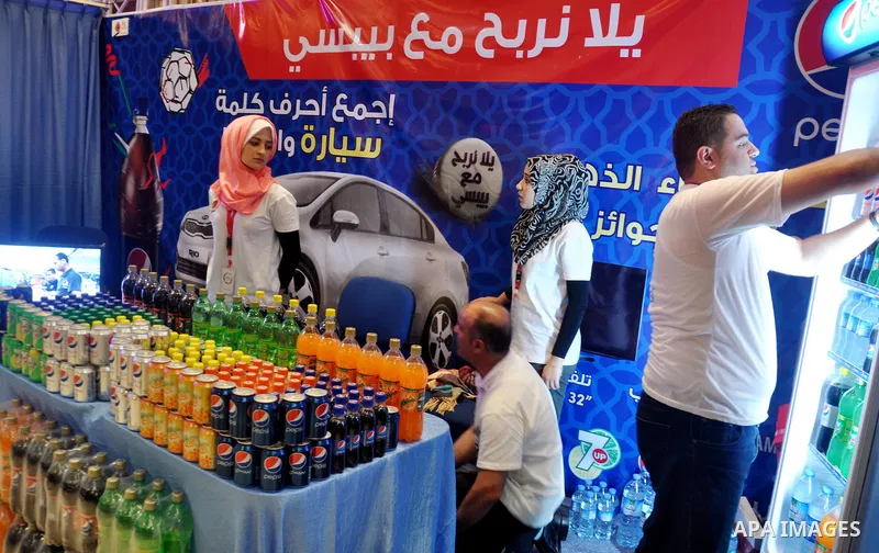 Palestinians take part in the Palestinian food exhibition, organized by the general union of Palestinian industries, in Gaza City on June 25, 2014. Photo by Mohammed Talatene