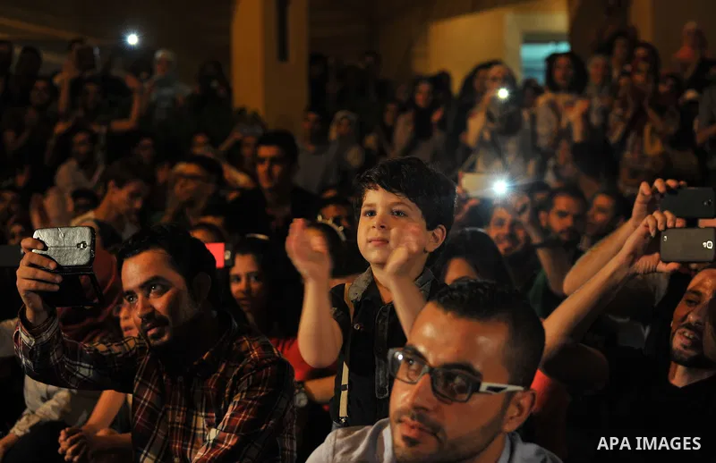 Palestinians take part in a concert in the courtyard of the French Cultural Center in Gaza City, on June 24, 2014. Photo by Ezz Zanoun
