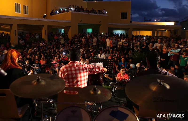 Palestinians take part in a concert in the courtyard of the French Cultural Center in Gaza City, on June 24, 2014. Photo by Ezz Zanoun