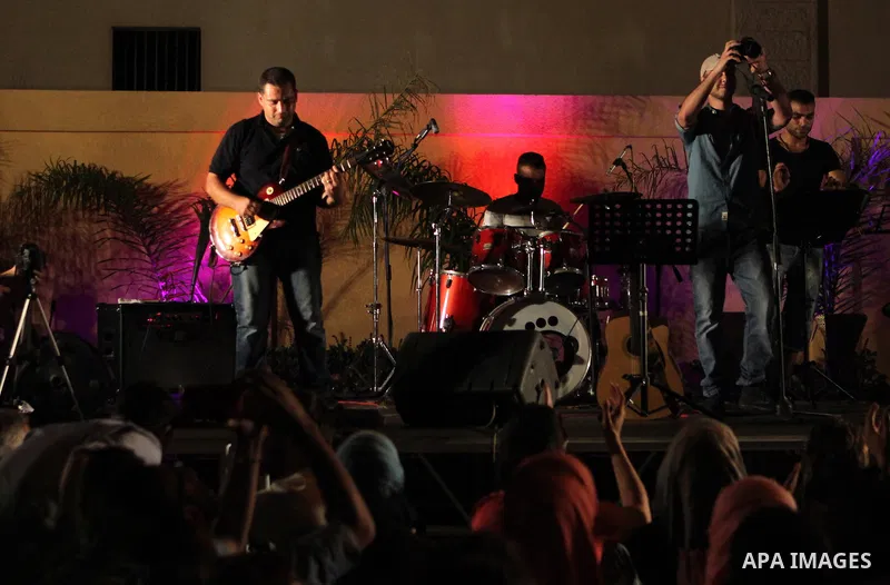 Palestinians take part in a concert in the courtyard of the French Cultural Center in Gaza City, on June 24, 2014. Photo by Ezz Zanoun