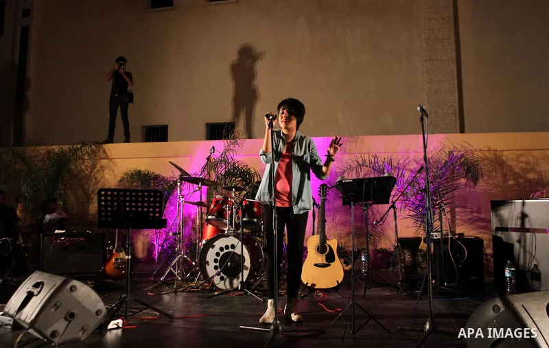 Palestinians take part in a concert in the courtyard of the French Cultural Center in Gaza City, on June 24, 2014. Photo by Ezz Zanoun