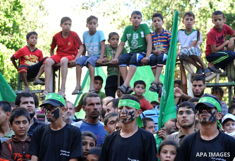 Palestinian children take part in a rally in solidarity with prisoners in Israeli jails and against the Israeli search operation for three missing Israeli teenagers in the West Bank, in Gaza City on June 25, 2014. Israel...