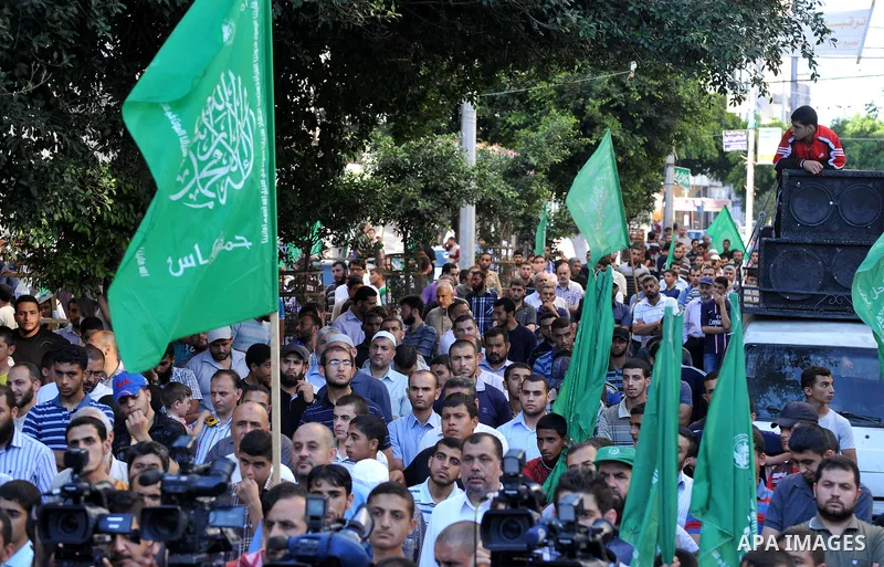 Palestinian supporters of Hamas movement take part in a rally in solidarity with prisoners in Israeli jails and against the Israeli search operation for three missing Israeli teenagers in the West Bank, in Gaza City on J...