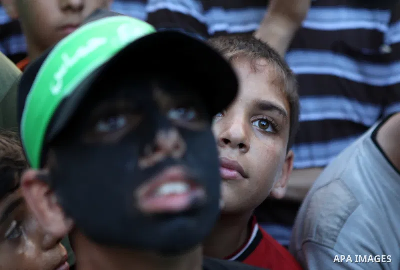 Palestinian children take part in a rally in solidarity with prisoners in Israeli jails and against the Israeli search operation for three missing Israeli teenagers in the West Bank, in Gaza City on June 25, 2014. Israel...