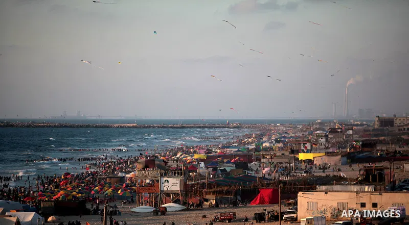 Palestinians enjoy a day on the beach in the central Gaza Strip June 26, 2014. Palestinian Environment Quality Authority said in a statement the pollution of the seawater has gone beyond 50 percent. The lack of enough fu...