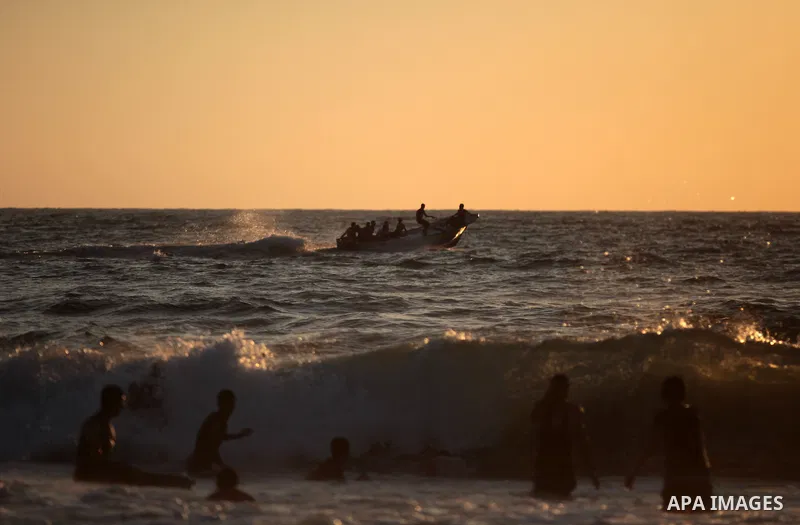Palestinians enjoy a day on the beach in the central Gaza Strip June 26, 2014. Palestinian Environment Quality Authority said in a statement the pollution of the seawater has gone beyond 50 percent. The lack of enough fu...