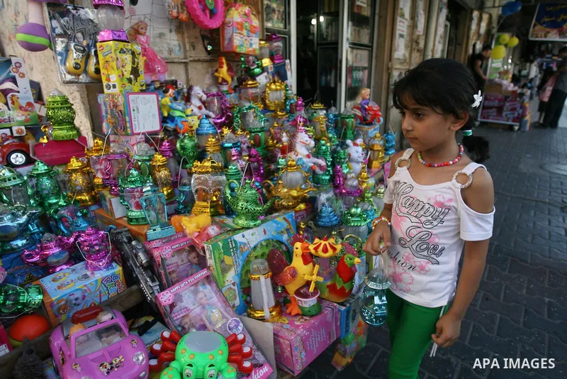 A Palestinian girl carries a traditional Ramadan lantern marking the holy month of Ramadan at a market in Rafah in the southern Gaza Strip, June 26, 2014. Muslims observe the dawn-to-dusk fasting during the holy month of...