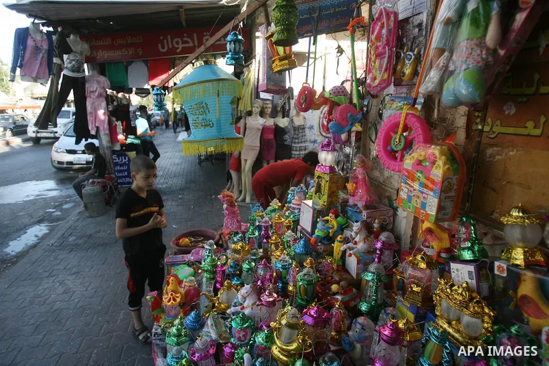 A Palestinian boy looks at traditional Ramadan lanterns in a shop marking the holy month of Ramadan at a market in Rafah in the southern Gaza Strip, June 26, 2014. Muslims observe the dawn-to-dusk fasting during the holy...