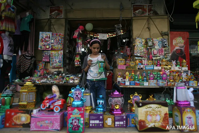 A Palestinian girl carries a traditional Ramadan lantern marking the holy month of Ramadan at a market in Rafah in the southern Gaza Strip, June 26, 2014. Muslims observe the dawn-to-dusk fasting during the holy month of...