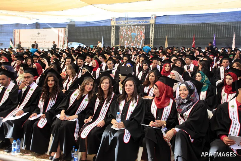 Palestinian students attend their graduation ceremony at the Birzeit University near the West Bank city of Ramallah, June 26, 2014. Photo by Issam Rimawi