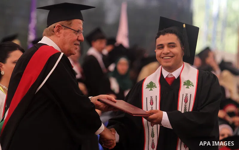 Palestinian students attend their graduation ceremony at the Birzeit University near the West Bank city of Ramallah, June 26, 2014. Photo by Issam Rimawi