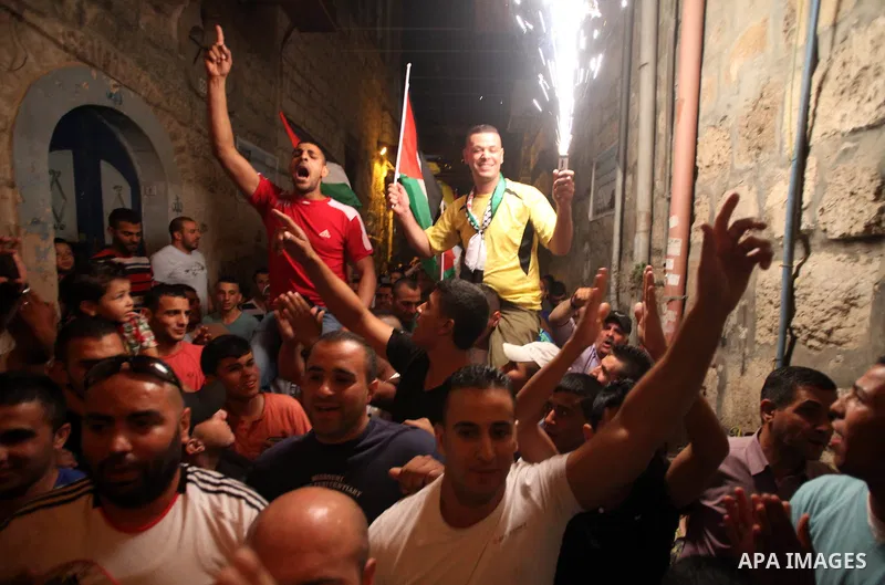Palestinian prisoner Wissam kashur, 34, is greeted by people as he celebrates his release from an Israeli jail in Jerusalem on June 26, 2014. Israel freed Kashur from jail on Thursday, after spent twelve years in its pri...