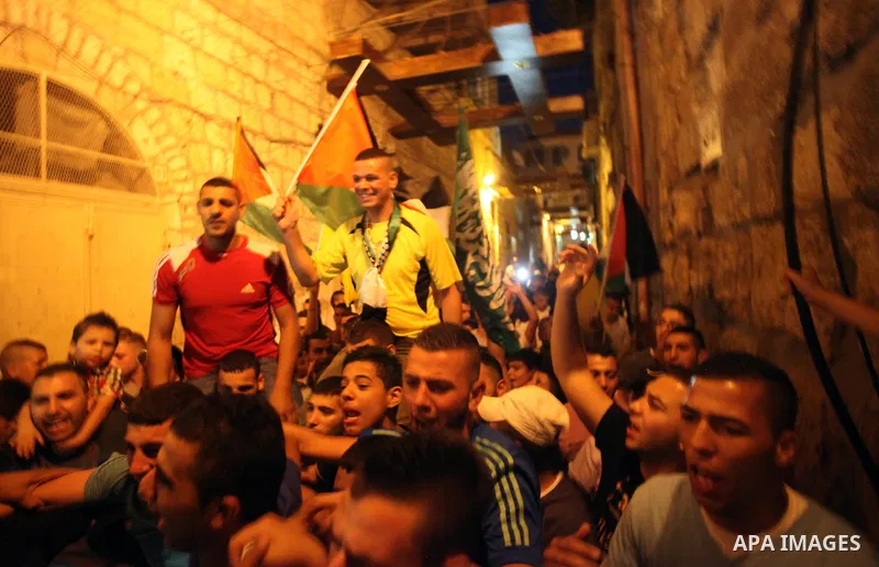 Palestinian prisoner Wissam kashur, 34, is greeted by people as he celebrates his release from an Israeli jail in Jerusalem on June 26, 2014. Israel freed Kashur from jail on Thursday, after spent twelve years in its pri...
