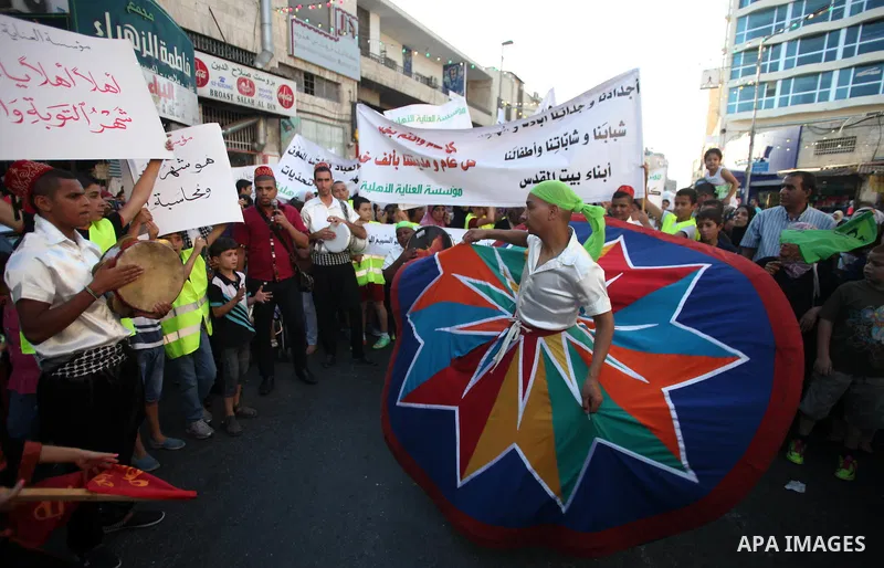 Members of a Palestinian Sufi Muslim group perform outside the old city of Jerusalem on June 26, 2014, as Muslims prepare for the upcoming holy fasting month of Ramadan. Muslims around the world celebrate Ramadan, the ho...