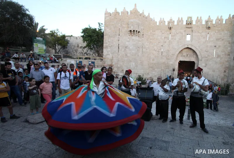Members of a Palestinian Sufi Muslim group perform in front of Damascus Gate outside the old city of Jerusalem on June 26, 2014, as Muslims prepare for the upcoming holy fasting month of Ramadan. Muslims around the world...