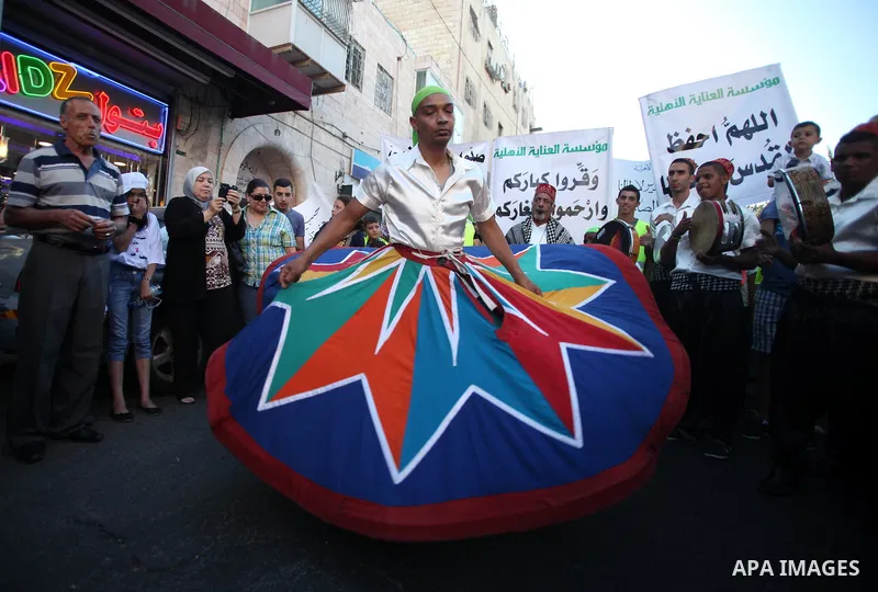 Members of a Palestinian Sufi Muslim group perform outside the old city of Jerusalem on June 26, 2014, as Muslims prepare for the upcoming holy fasting month of Ramadan. Muslims around the world celebrate Ramadan, the ho...