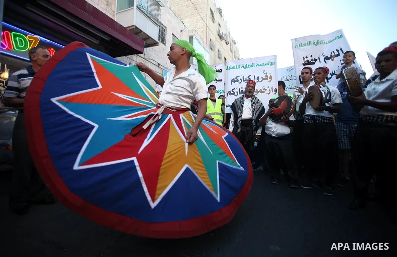Members of a Palestinian Sufi Muslim group perform outside the old city of Jerusalem on June 26, 2014, as Muslims prepare for the upcoming holy fasting month of Ramadan. Muslims around the world celebrate Ramadan, the ho...