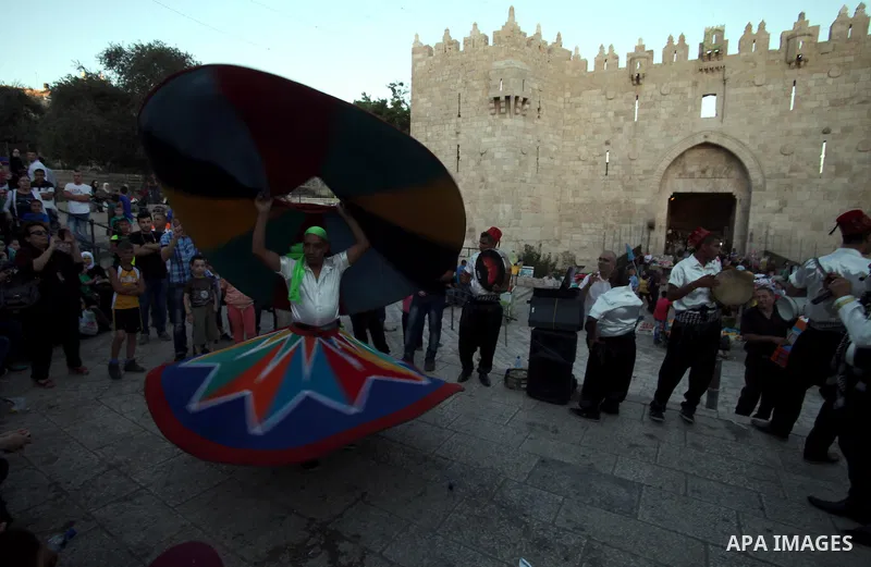 Members of a Palestinian Sufi Muslim group perform in front of Damascus Gate outside the old city of Jerusalem on June 26, 2014, as Muslims prepare for the upcoming holy fasting month of Ramadan. Muslims around the world...