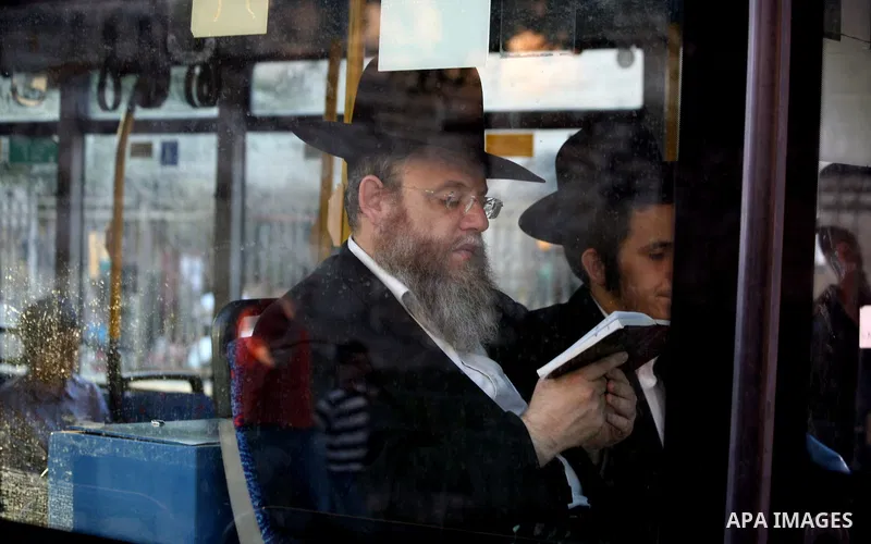 Ultra Orthodox Jews ride a bus in front of Damascus Gate outside the old city of Jerusalem on June 26, 2014. Photo by Saeed Qaq