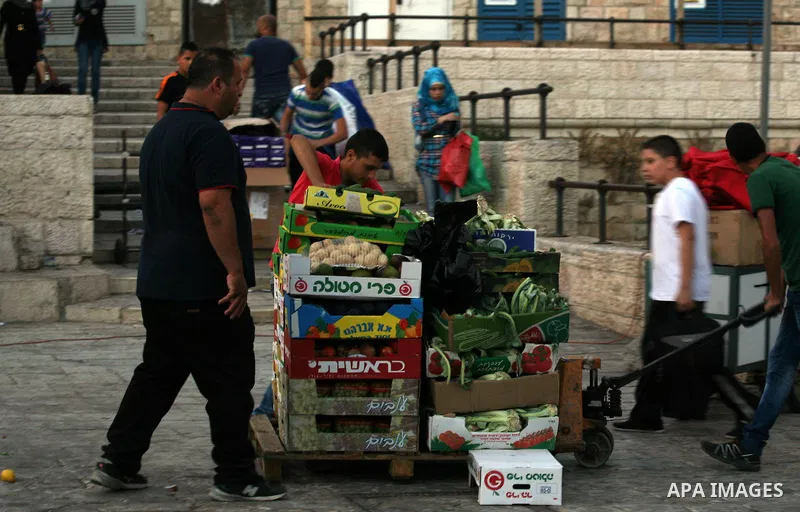 Palestinians shop at a street market in front of Damascus Gate outside the old city of Jerusalem on June 26, 2014, as Muslims prepare for the upcoming holy fasting month of Ramadan. Muslims around the world celebrate Ram...