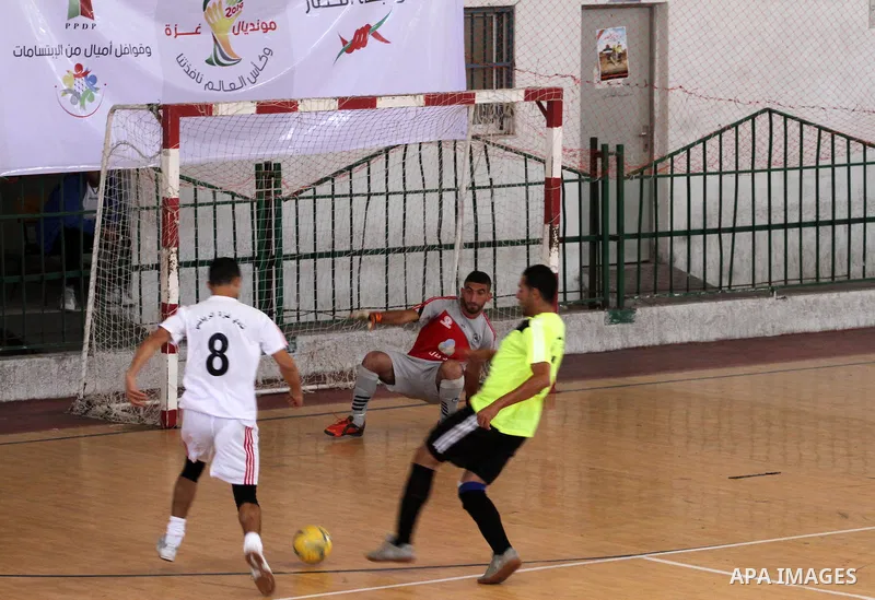 Palestinian football players participate in a match the during the championship of ''Gaza World Cup", in an event against the Israeli blockade on Gaza Strip, in Gaza City on June 27, 2014. Palestinians share a billion or...
