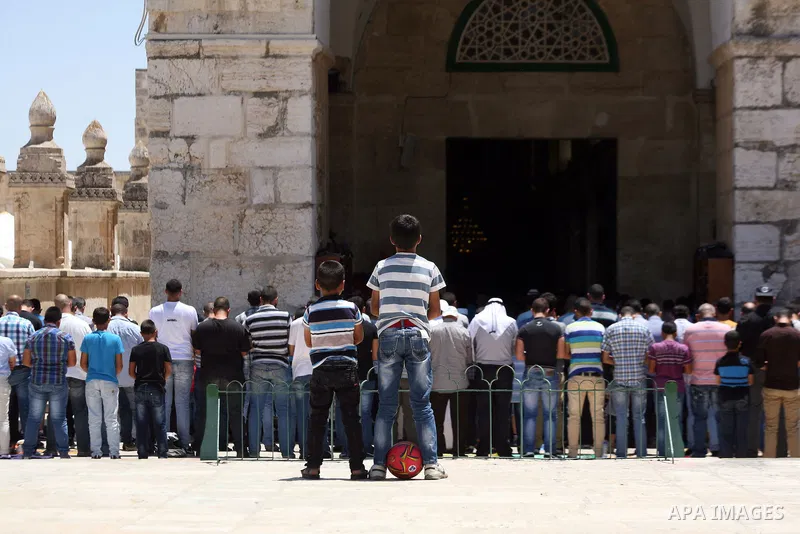 Palestinian Muslim worshipers take part in Friday prayers at the Al-Aqsa mosque compound, Islam's third holiest site, in the Old City of Jerusalem on June 27, 2014. Photo by Saeed Qaq