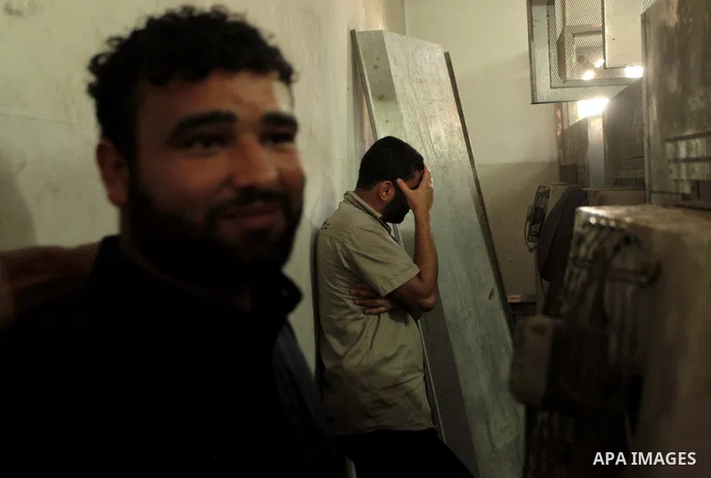 Palestinians mourn the death of two Palestinian militants outside a hospital morgue in Gaza City June 27, 2014. An Israeli air strike killed two Palestinian militants and critically wounded a third in the Gaza Strip on F...