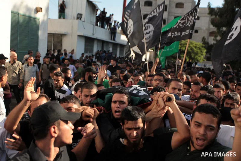 Mourners carry the bodies of Palestinian militant Osama al-Hosomi and Mohammed Fasih during their funeral in Gaza City, June 27, 2014. An Israeli air strike killed two Palestinian militants and critically wounded a third...