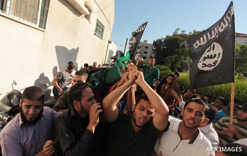 Mourners carry the bodies of Palestinian militant Osama al-Hosomi and Mohammed Fasih during their funeral in Gaza City, June 27, 2014. An Israeli air strike killed two Palestinian militants and critically wounded a third...