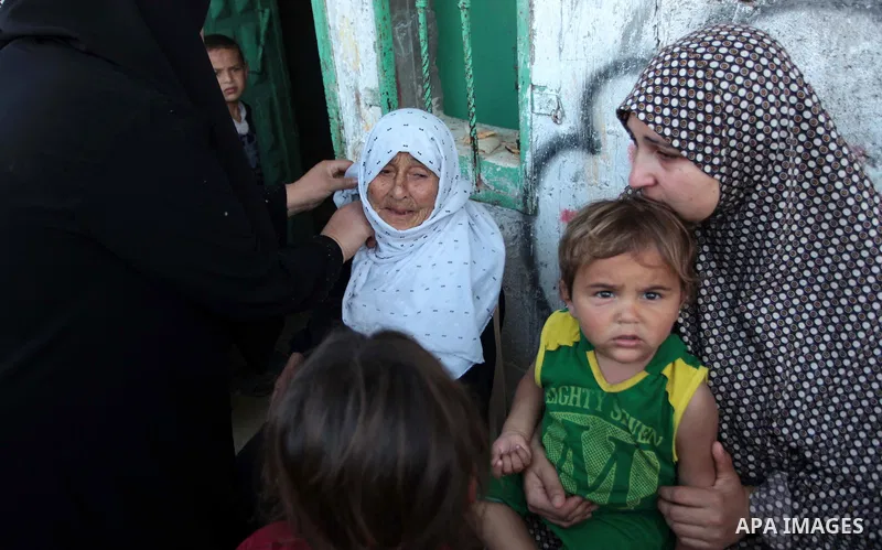 Palestinian relatives of Osama al-Hosomi mourn during his funeral in the northern Gaza Strip June 27, 2014. An Israeli air strike killed two Palestinian militants, one of them al-Hosomi, and critically wounded a third in...