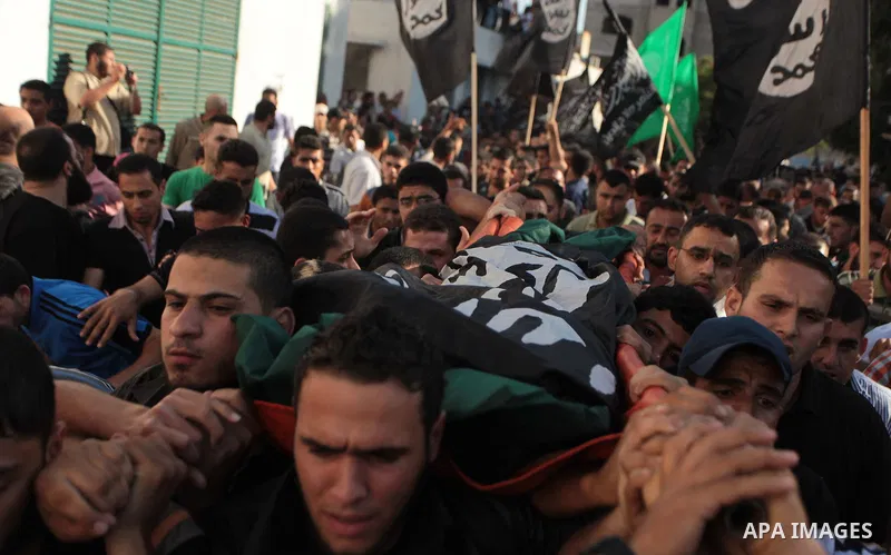 Mourners carry the bodies of Palestinian militant Osama al-Hosomi and Mohammed Fasih during their funeral in Gaza City, June 27, 2014. An Israeli air strike killed two Palestinian militants and critically wounded a third...
