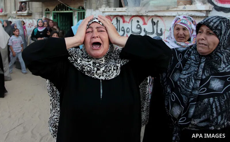 A Palestinian relative of Osama al-Hosomi mourns during his funeral in the northern Gaza Strip June 27, 2014. An Israeli air strike killed two Palestinian militants, one of them al-Hosomi, and critically wounded a third...