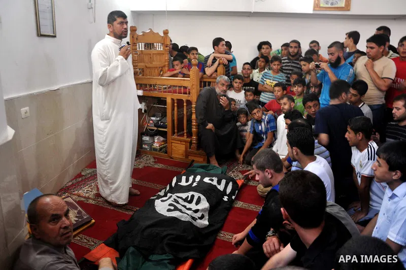 Palestinians pray over the body of Mohammed al-Fasih, during his funeral in Gaza City on June 27, 2014. An Israeli air strike killed two Palestinian militants and critically wounded a third in the Gaza Strip on Friday, t...