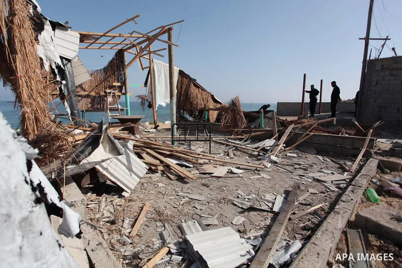 Palestinian security forces inspect the site of an Israeli air strike, in the central Gaza Strip, on June 28, 2014. Israel's army launched airstrikes on southern and central Gaza early Saturday after projectiles fired fr...