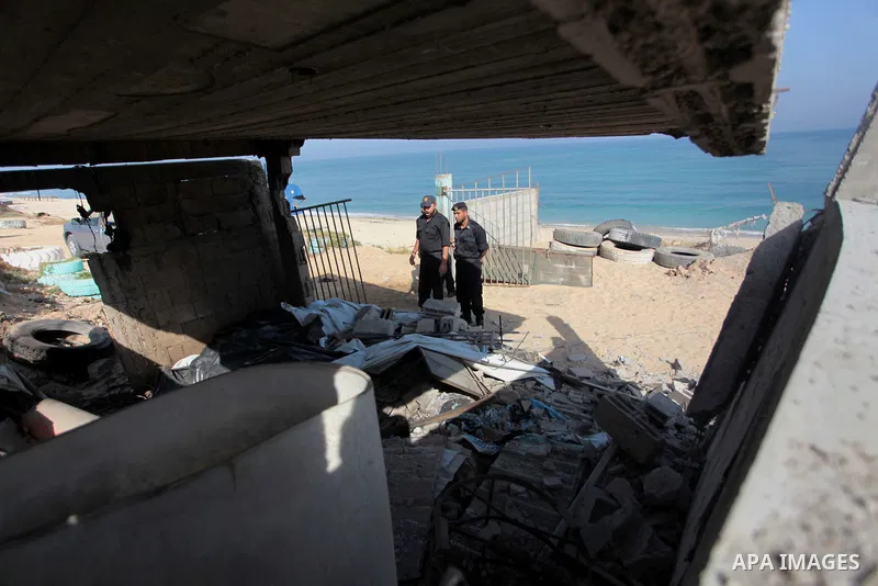 Palestinian security forces inspect the site of an Israeli air strike, in the central Gaza Strip, on June 28, 2014. Israel's army launched airstrikes on southern and central Gaza early Saturday after projectiles fired fr...