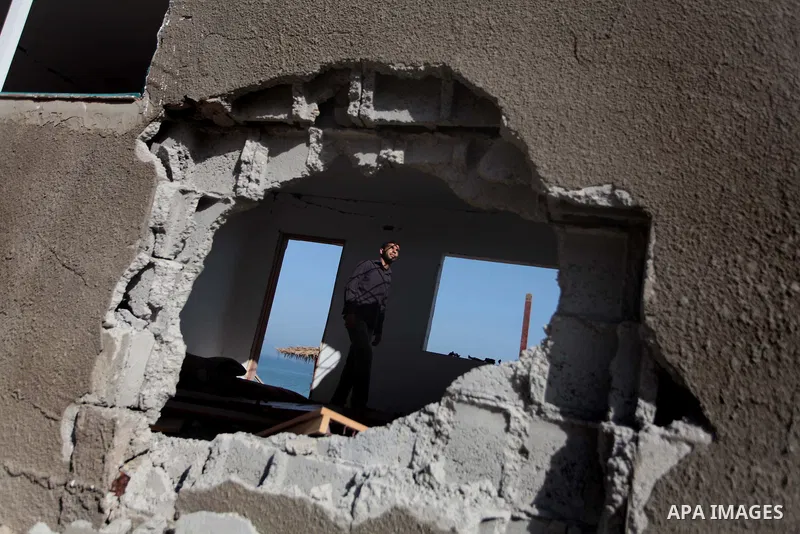 Palestinian security forces inspect the site of an Israeli air strike, in the central Gaza Strip, on June 28, 2014. Israel's army launched airstrikes on southern and central Gaza early Saturday after projectiles fired fr...