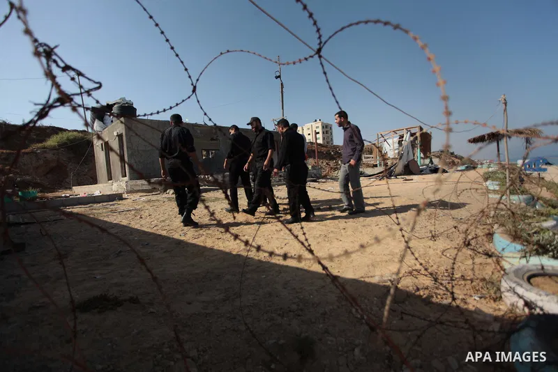 Palestinian security forces inspect the site of an Israeli air strike, in the central Gaza Strip, on June 28, 2014. Israel's army launched airstrikes on southern and central Gaza early Saturday after projectiles fired fr...