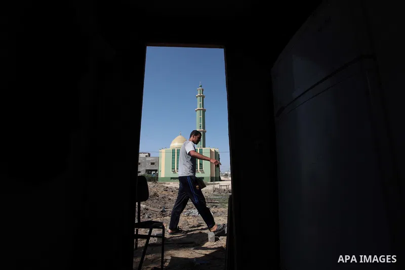 A Palestinian man inspects a land damaged in an Israeli air strike in the central Gaza Strip, on June 28, 2014. Israel's army launched airstrikes on southern and central Gaza early Saturday after projectiles fired from t...