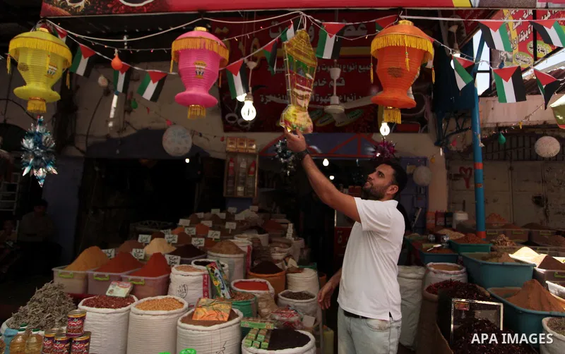 A Palestinian man sells spices in his shop at a market in Gaza City, as Muslims prepare for the upcoming holy fasting month of Ramadan, on June 28, 2014. on the eve of the start of the Muslim holy month of Ramadan. Durin...