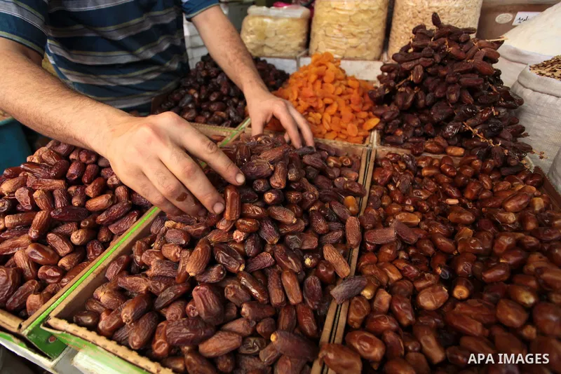 A Palestinian man sells dates in his shop at a market in Gaza City, as Muslims prepare for the upcoming holy fasting month of Ramadan, on June 28, 2014. on the eve of the start of the Muslim holy month of Ramadan. During...
