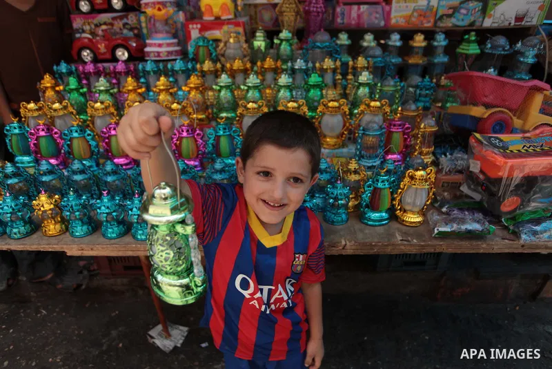 A Palestinian boy carries a traditional Ramadan lantern at a market in Gaza City, as Muslims prepare for the upcoming holy fasting month of Ramadan, on June 28, 2014. on the eve of the start of the Muslim holy month of R...