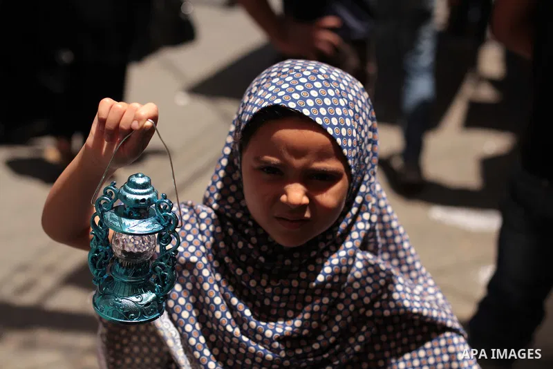 A Palestinian girl carries a traditional Ramadan lantern at a market in Gaza City, as Muslims prepare for the upcoming holy fasting month of Ramadan, on June 28, 2014. on the eve of the start of the Muslim holy month of...